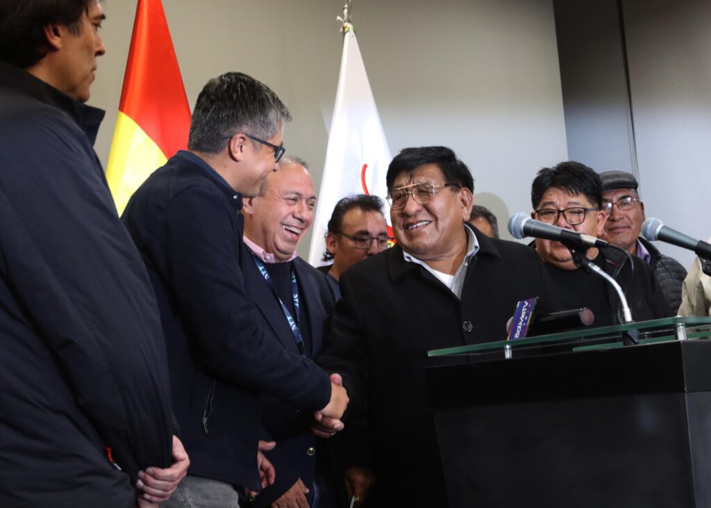 El ministro José Gabriel Espinoza se saluda con el dirigente Lucio Gómez. / Foto: Gobierno.