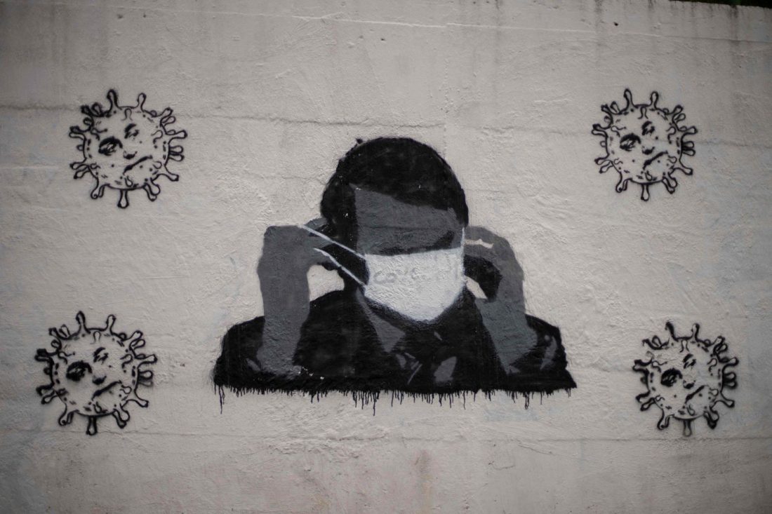 Un grafiti en una calle de Río de Janeiro del presidente Jair Bolsonaro con una mascarilla.