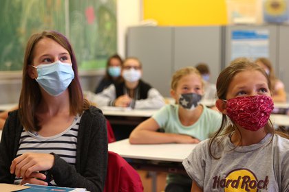 Alumnas de quinto año usan voluntariamente máscaras protectoras dentro de su aula cuando las escuelas vuelven a abrir después de las vacaciones de verano en la escuela secundaria Karl-Rehbein en Hanau, Alemania (Reuters)