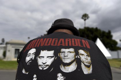 A fan wearing a Soundgarden T-shirt reacts following a funeral for Chris Cornell at the Hollywood Forever Cemetery on Friday, May 26, 2017, in Los Angeles. (Photo by Chris Pizzello/Invision/AP)