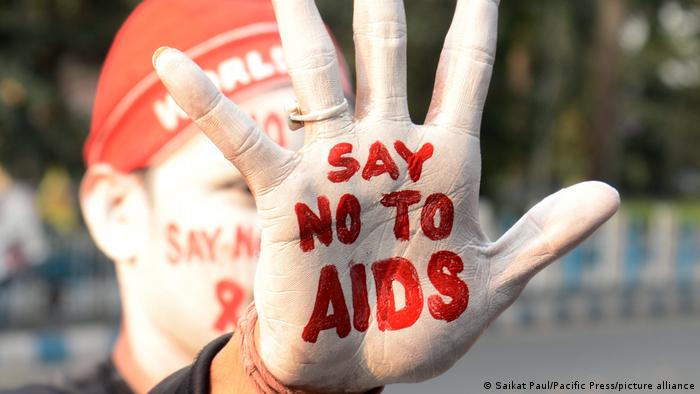 Un hombre extiende la mano hacia la cámara, donde se lee: Di 'no' al sida.