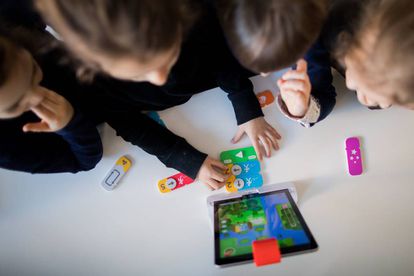 Niños en una guardería alemana aprendendiendo a programar con un iPad ejecutando comandos de bloques.