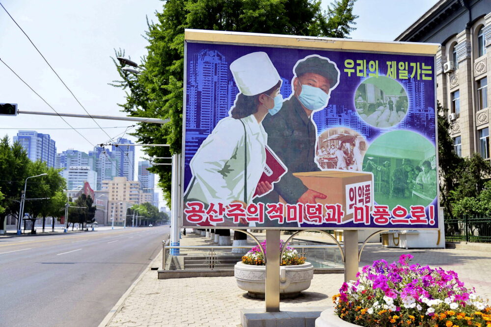 Un letrero que muestra una escena de transporte de productos médicos se muestra en la calle vacía en Pyongyang, Corea del Norte, en esta foto del 23 de mayo. 2022. (Kyodo vía REUTERS)