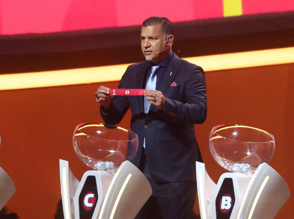 Soccer Football - World Cup - Final Draw - Doha Exhibition & Convention Center, Doha, Qatar - April 1, 2022 Draw assistant Ali Daei draws C1 REUTERS/Ahmed Jadallah