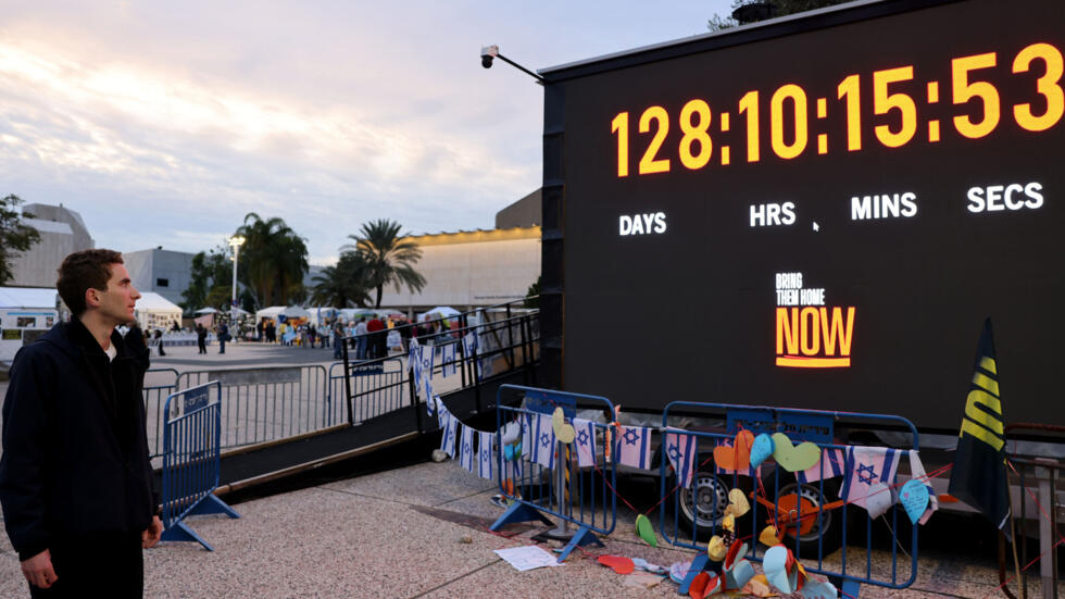 Un hombre observa el 12 de febrero de 2024 en Tel-Aviv, en "la plaza de los rehenes", el reloj mural que indica el número de días, horas, minutos y segundos transcurridos desde el 7 de octubre, día del ataque sangriento del movimiento palestino Hamás, cuando 250 personas fueron secuestradas y llevadas a Gaza.