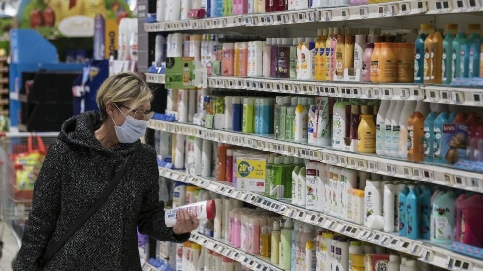 Foto de ilustración de una mujer en el sector de higiene de un supermercado.