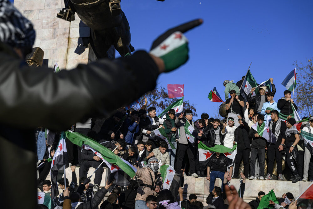 Sirios residentes en Turquía celebran la caída del presidente Bashar el Asad con banderas de la oposición siria, el 8 de diciembre de 2024 en Estambul