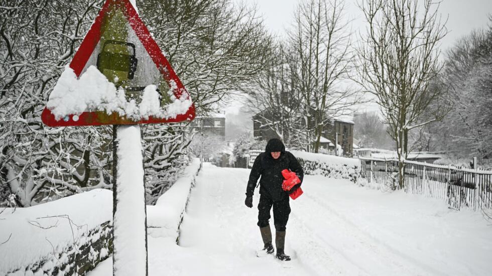 Un hombre camina entre la nieve en Marsden, en el norte de Inglaterra, el 5 de enero de 2025