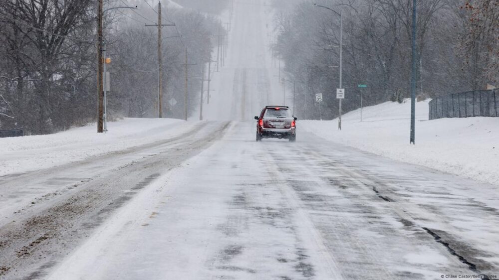 Un vehículo circula con precaución por una carretera nevada en Shawnee, Kansas. (05.01.2025)