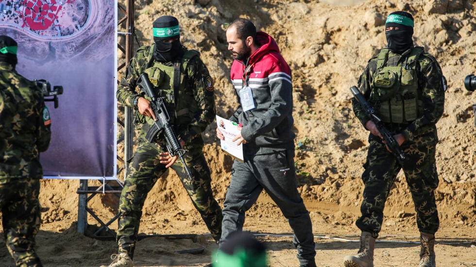 Combatientes de Hamás escoltan al rehén israeli Yarden Bibas antes de entregarlo a la Cruz Roja para su liberación, en Jan Yunis, Gaza, el 1 de febrero de 2025