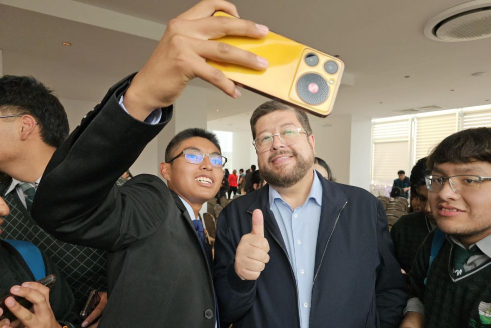 El precandidato presidencial Samuel Doria Medina se toma una fotografía con un estudiante. 