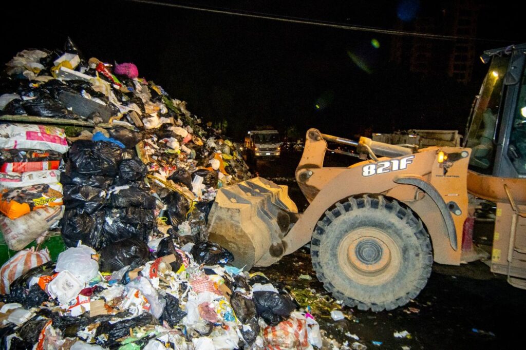 Un tractor levanta la basura acumulada en el centro de Cochabamba. / Foto: GAMC.