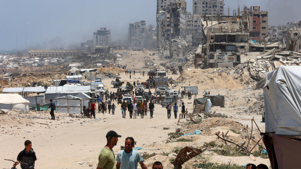 Palestinos huyen del norte de la Franja de Gaza hacia el sur, a lo largo de la carretera costera al-Rashid el 25 de mayo de 2025