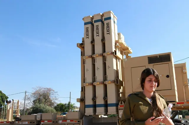 Un reservista israelí se encuentra junto a una batería del sistema de defensa aérea Honda de David.
