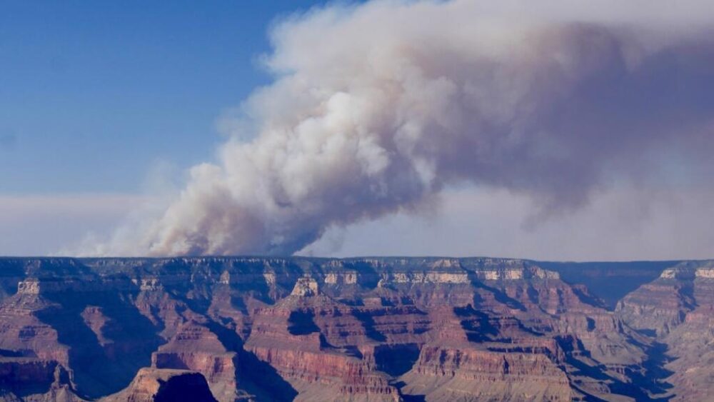 Una enorme columna de humo se alza sobre el Gran Cañón, acechado por las llamas