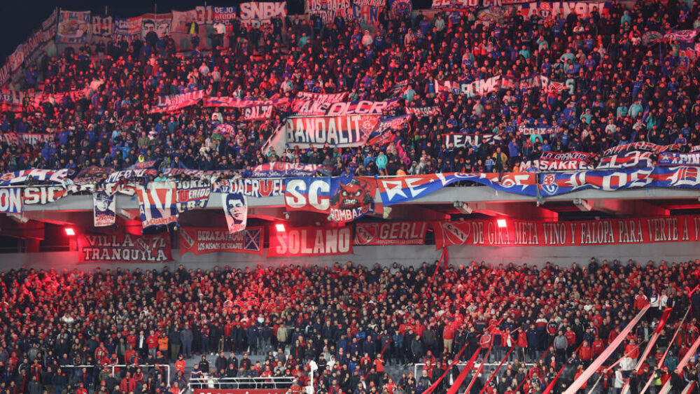 Supporters of Independiente (Bottom) and Universidad de Chile (Top) watch the Copa Sudamericana round of 16 second leg football match between Argentina's Independiente and Chile's Universidad de Chile at the Libertadores de America stadium in Avellaneda, Buenos Aires province, Argentina on August 20, 2025. The match between Independiente and Universidad de Chile was suspended due to incidents in the stands during the second half, according to the Argentine club and confirmed by Conmebol. The score was tied 1-1.