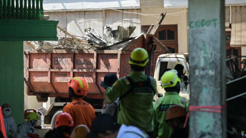 A truck loaded with debris leaves the site of the collapsed school on October 6